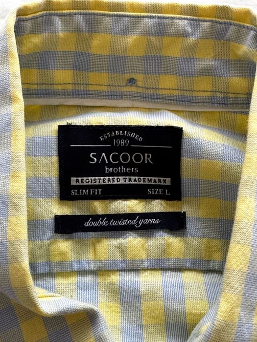 Camisa Sacoor amarela e azul