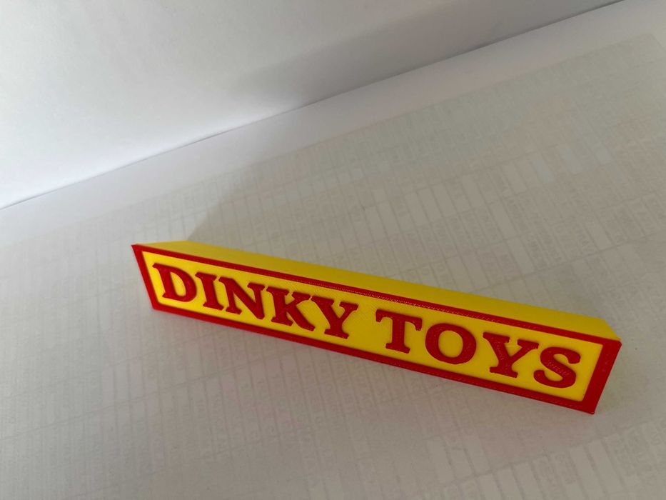 Sinal DINKY TOYS p/expositor miniaturas, paral. triang.reg., amarelo