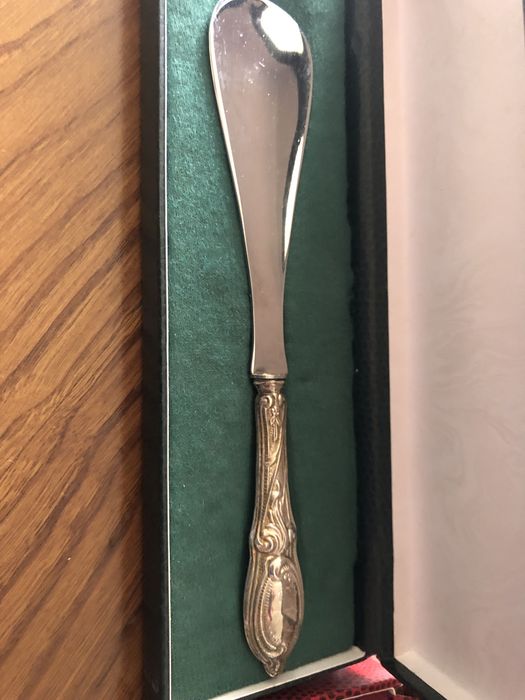 Two different shoe trees and a silver letter opener