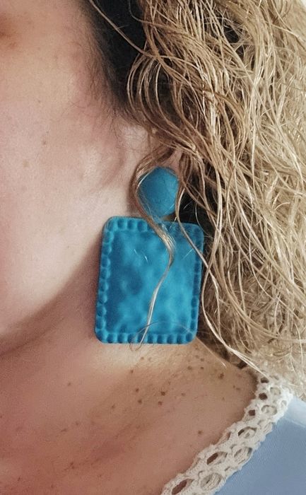 Brincos grandes em azul petróleo. De pico.