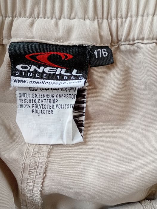 Spodnie męskie letnie marki Coneill, rozmiar 176, kolor beżowy.