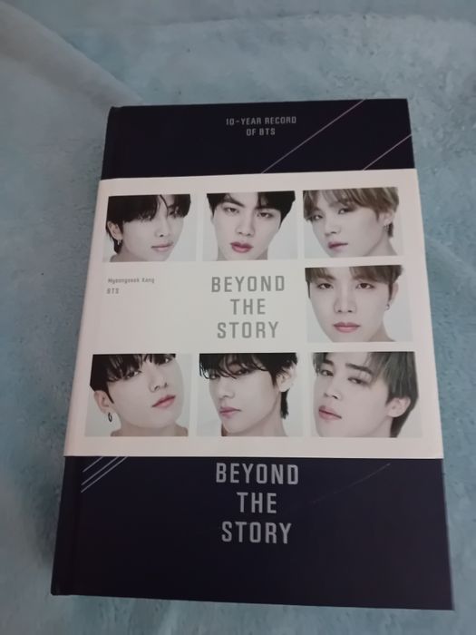 Vendo livro sobre a vida do grupo BTS