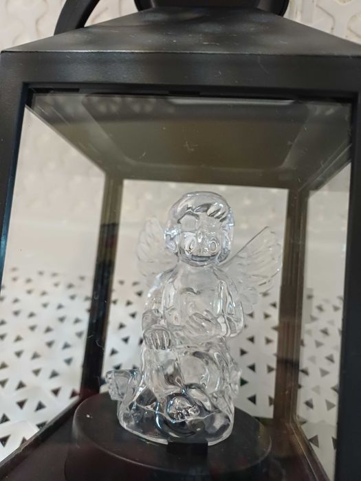 Mały czarny lampion ze świecącym aniołkiem.