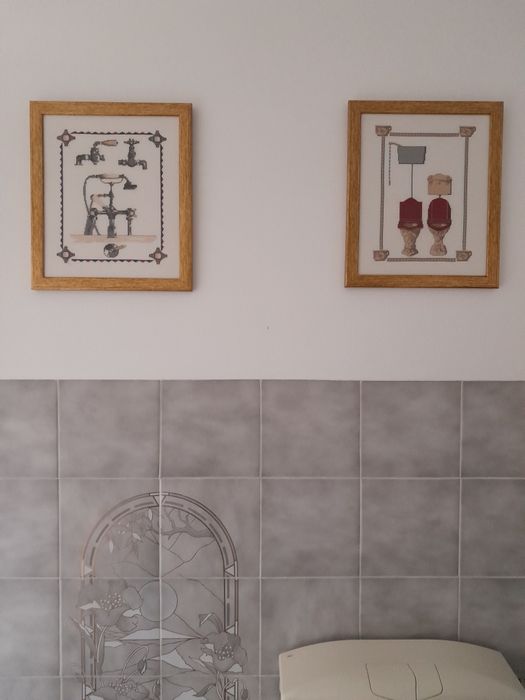 Dois quadros /emoldurados dourado e ,em ponto cruz.