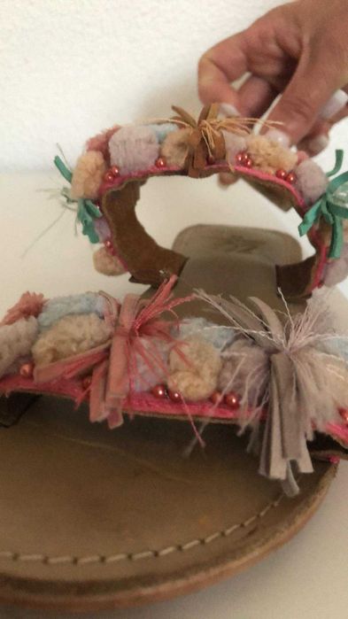 Sandália em pele de menina com pompons