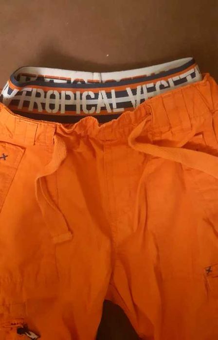 Pomarańczowe spodnie sportowe dla chłopca H&M 92