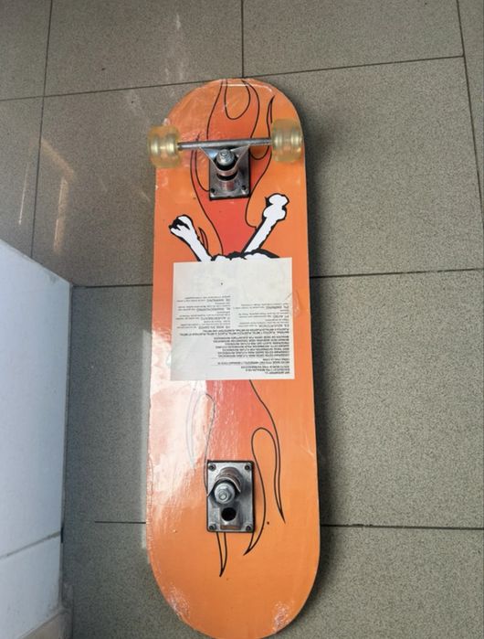 Black skatebroad with orange graphic