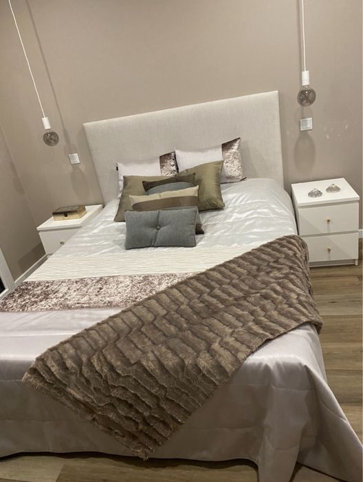 Colcha em tons de cinza e duas almofadas