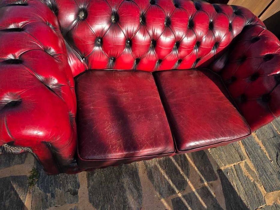 Sofas chesterfield com sinais de uso, um de três lugares e outro de dois lugares