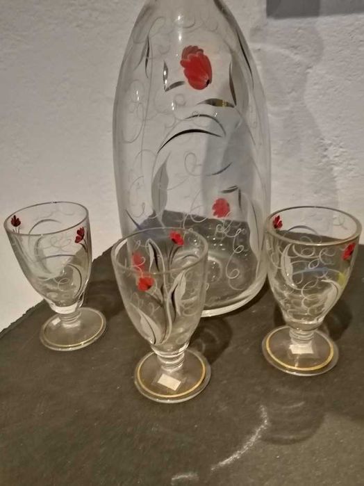 Garrafa de licor e três copos em vidro