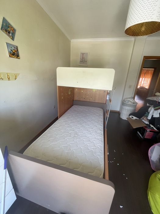 Quarto de criança com cama, secretaria e prateleira