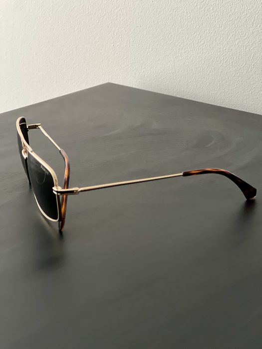 Oculos de sol dourados Polaroid