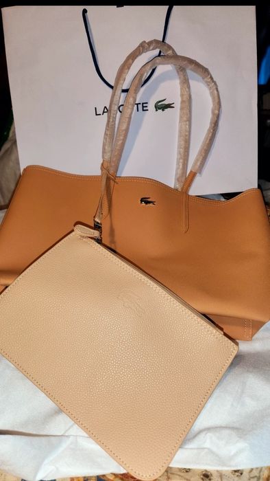 Com 60%  Bolsa Lacoste+ necessaire+ dustbag+ saco