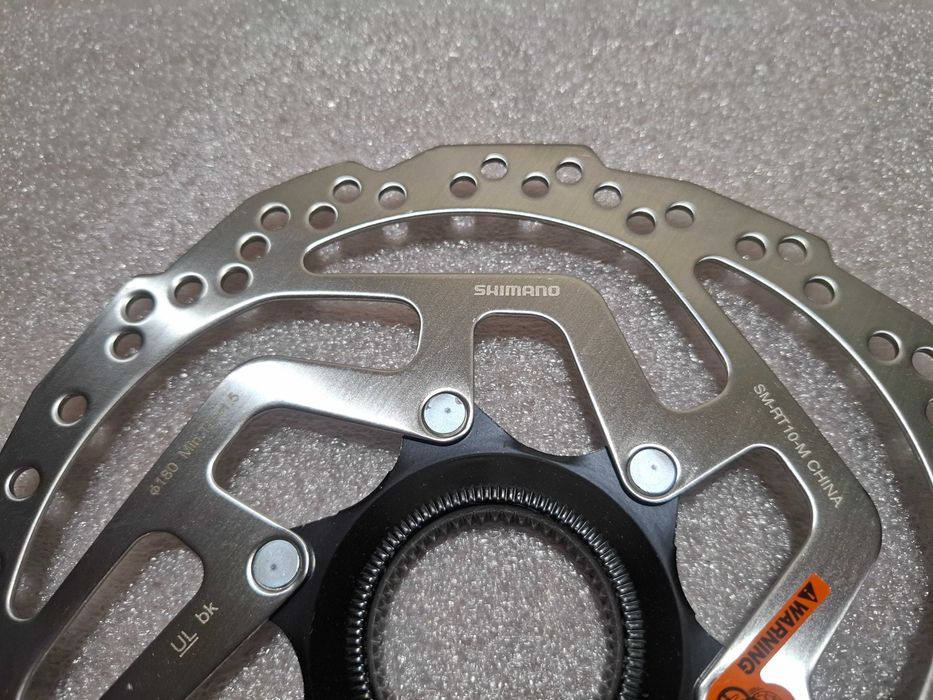 Tarcza Hamulca Rowerowego Shimano SM-RT10 180 Nowa Centerlock Nakrętka