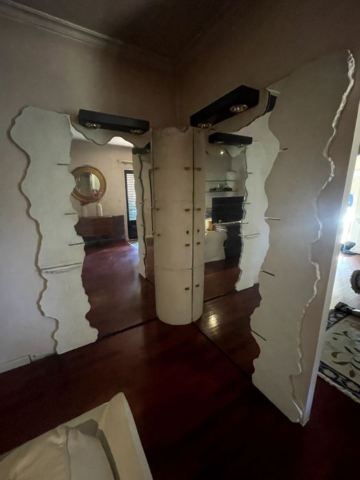 Bar de pedra com espelhos e vidros.