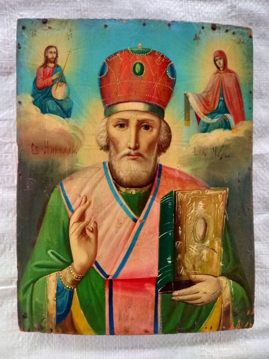 Старовинна ікона Святого Миколая Чудотворця на дерев’яній дошці.  Старинная икона Святого Николая Чудотворца на деревянной доске.