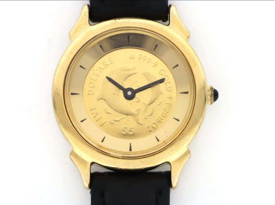 Zegrarek ,,Christian Riese Lassen Dolphin coin watch '' z ok.1995 przedmiot kolekcjonerski lub użytkowy.