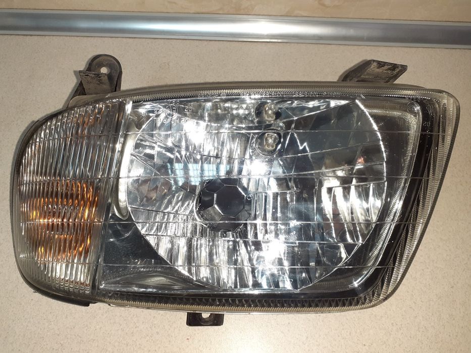 lampa przednia lewa reflektor DAIHATSU CUORE 98-02r.