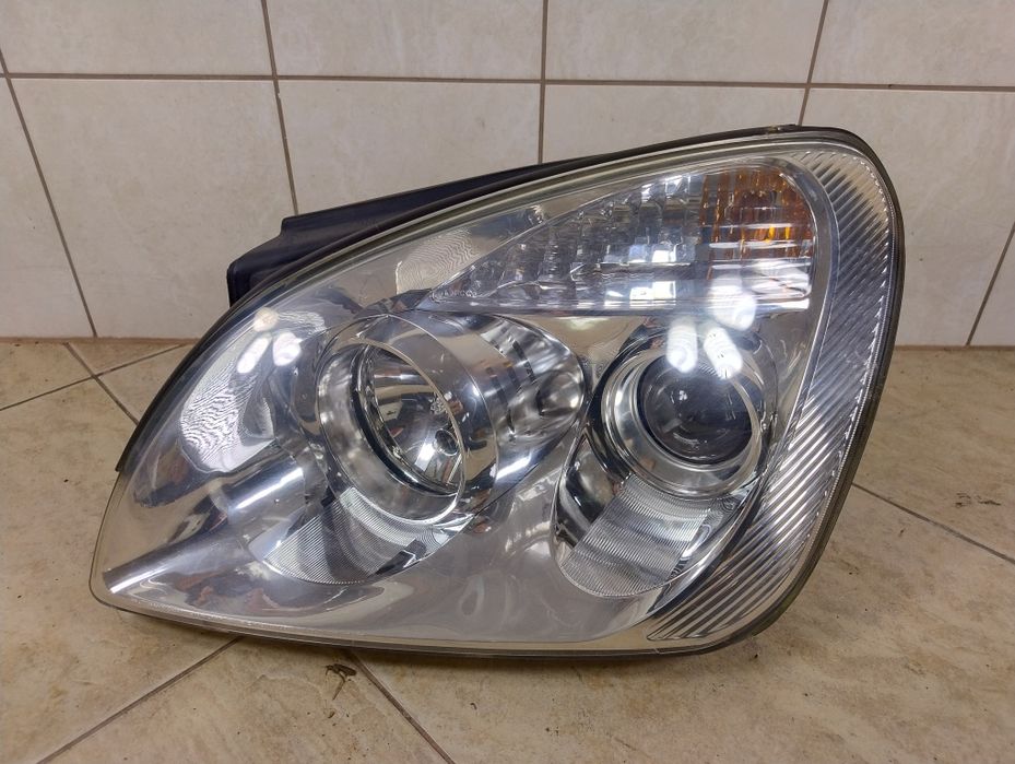 Kia carens 06-13 lampa reflektor lewy przód Europa wysyłka oryginał
