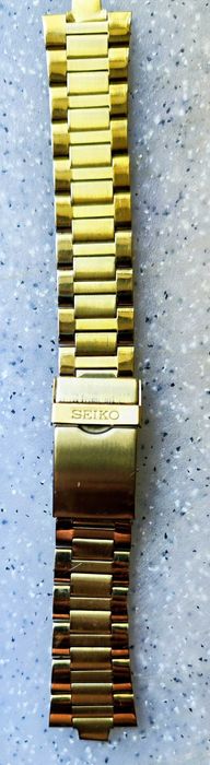 Металевий золотистий браслет для годинника Seiko.