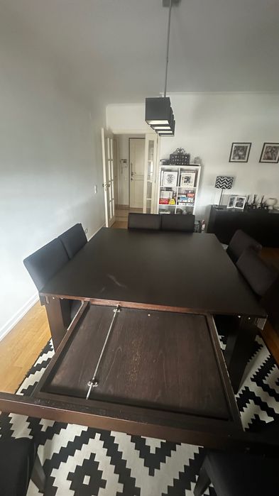Mesa extensível castanha escura Interdesign  com 8 cadeiras cremes de pele pêssego.