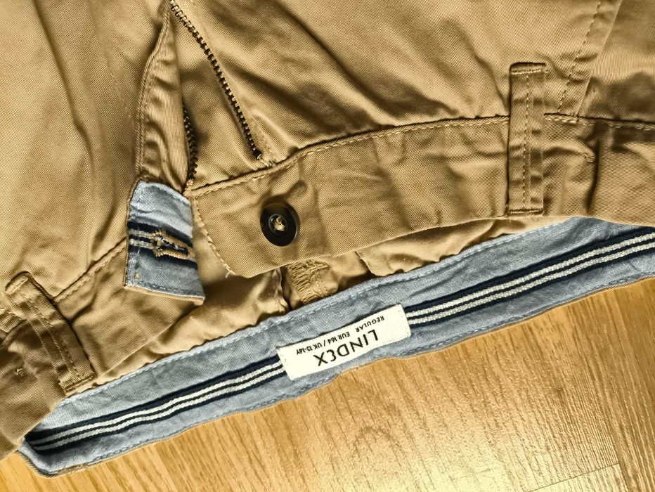 Kremowe eleganckie spodnie chłopięce Lindex, rozmiar 164