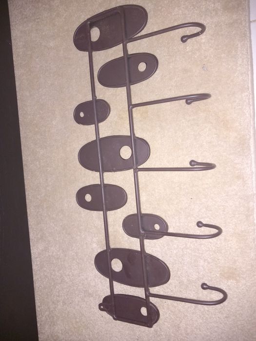 Cabide de metál em tons dourados castanhos e preto está como novo