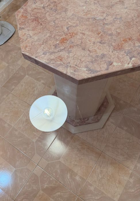Mesa de jantar oitavada com base de mármore e tampo de vidro