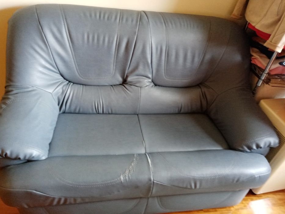 Sofá em pele sintética cor azul petróleo usado um pouco danificado