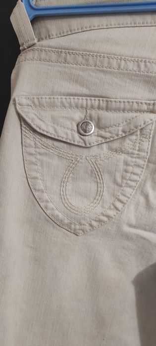 Beżowe spodnie z cyrkoniami 38