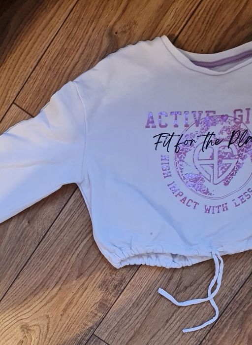 Krótka biała bluza z błyszczącym napisem rozm. 140