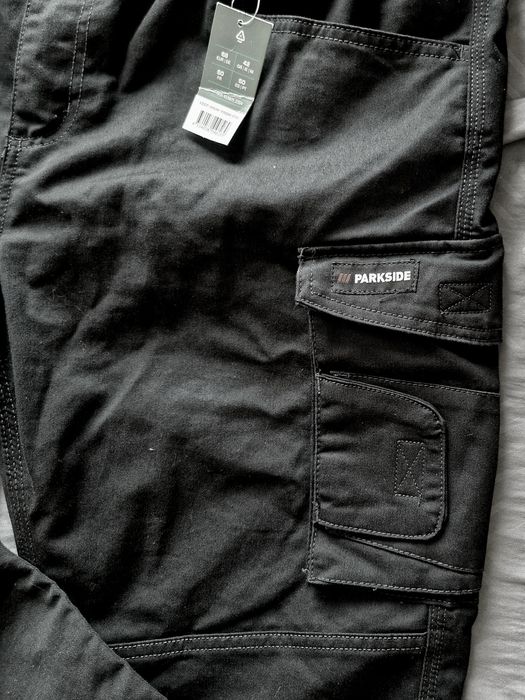 Calças de trabalho novas a estrear multibolsos em preto e cinza 
Elást