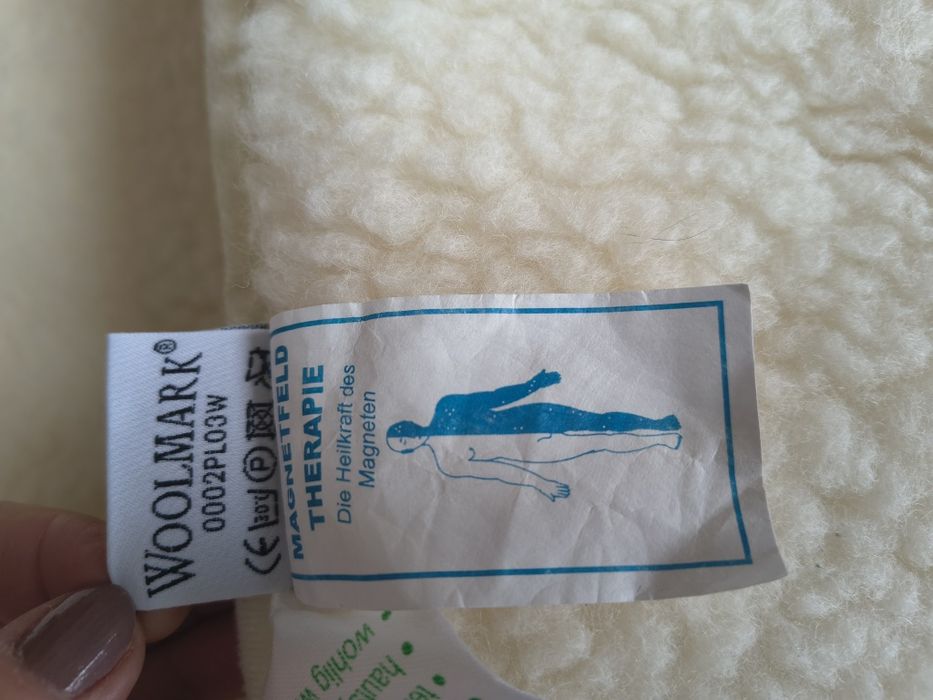 Wełniana podkładka lecznicza Woolmark.