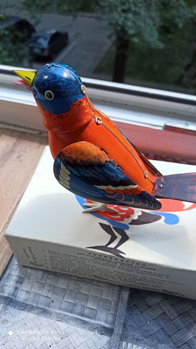 Детская механическая игрушка птица.