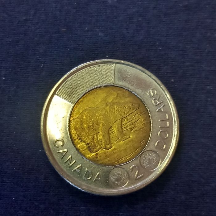 Moedas dólar Canadá e liras Itália