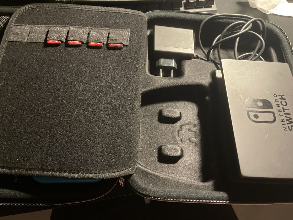 Nintendo Switch, games, charger, bag, and carrying case64284554711555123