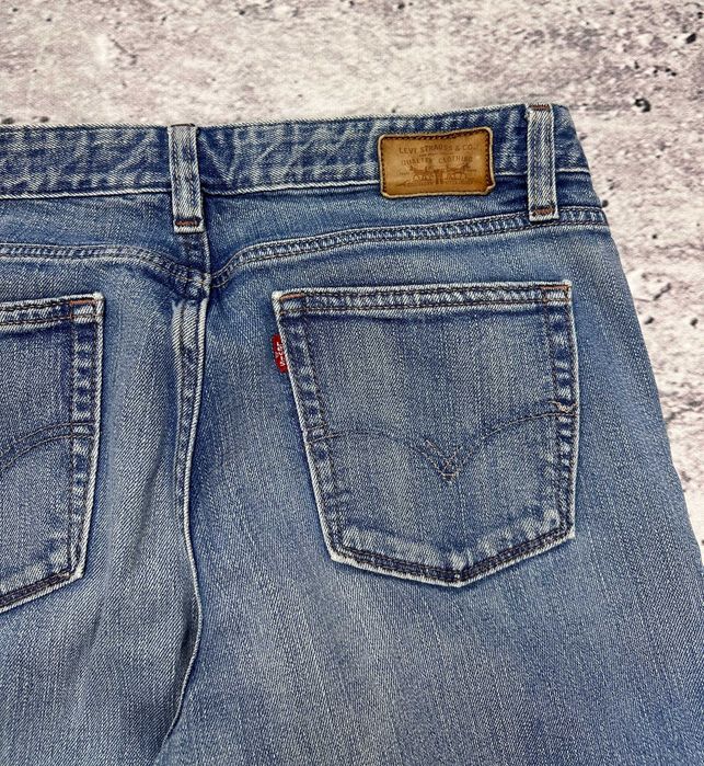 Spodnie jeansowe LEVIS 553 Mid-Rise Boot dzwony damskie szerokie W29