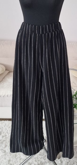 Spodnie szerokie nogawki H&M".