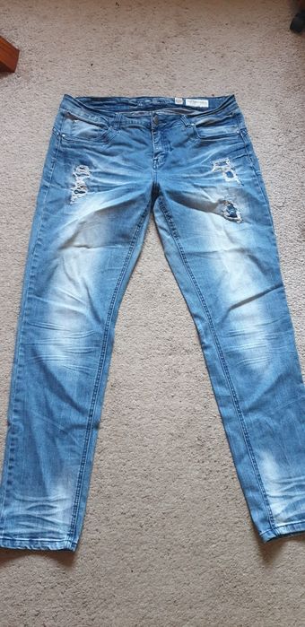 Spodnie jeansy z przetarciami.