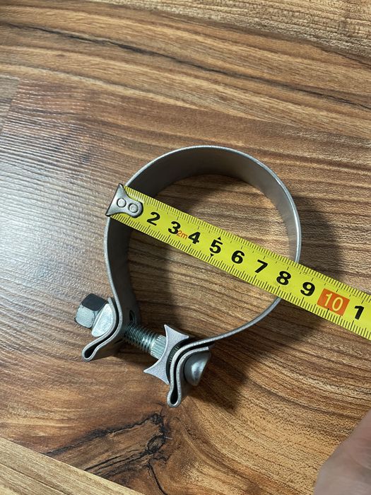 Новый алюминиевый хомут 75-80 мм.