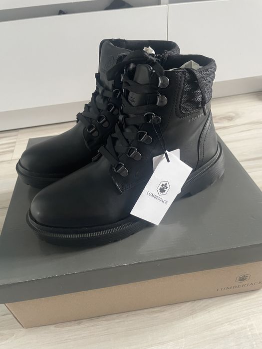 Lumberjack woman black boots winks