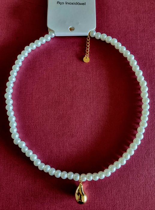 Colar de pérolas com acabamento e pingente em forma de gota, em aço.