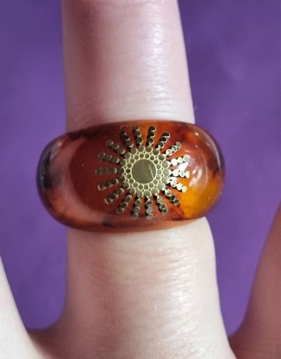 Anel em acrílico castanho com sol dourado, em aço. T17