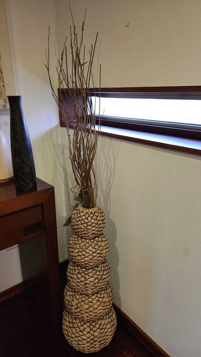 Peça decorativa em verga bege com ramos secos