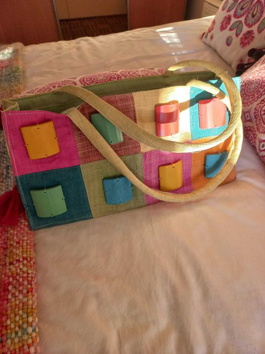 Colorful straw suitcase with wooden appliqués