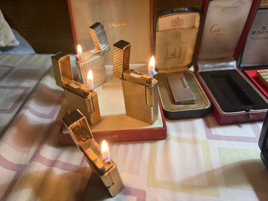 11 isqueiros 4 Dupont 1 Cartier 1 Dunhill 2 Ronson 2 Zippo 1 Zaima