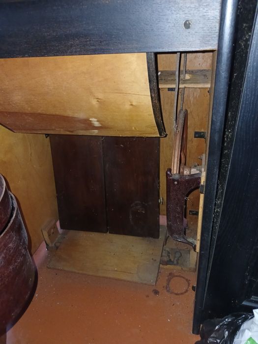 Швейная машинка с ножным приводом находится в тумбочке