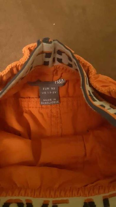 Pomarańczowe spodnie sportowe dla chłopca H&M 92