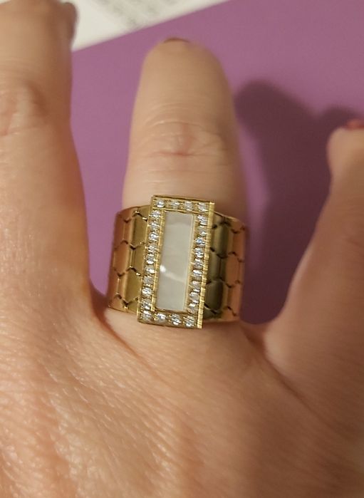 Anel dourado, em aço trabalhado, com uma madrepérola retangular rodeada de zirconias. T18