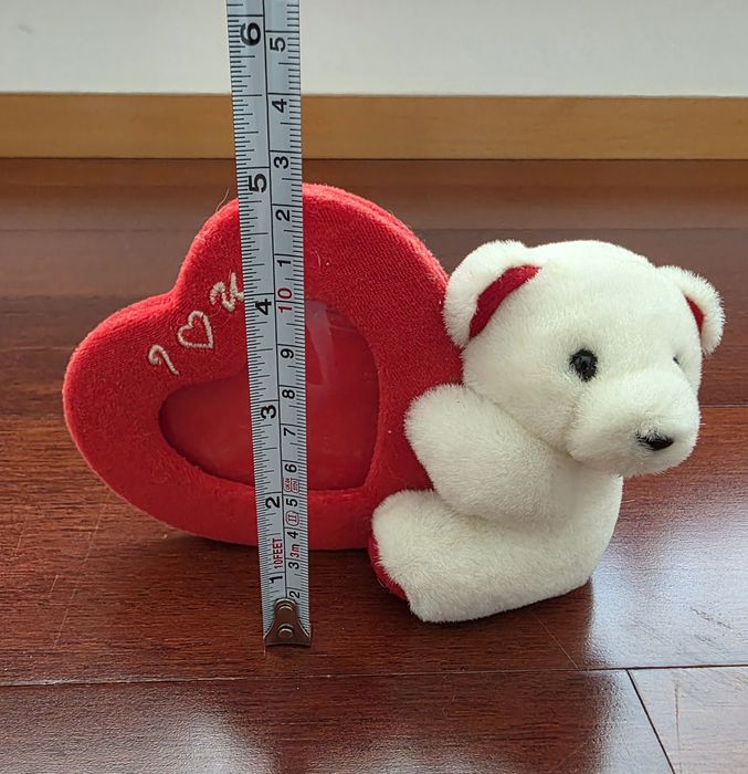 Moldura em formato de coração com um urso de peluche